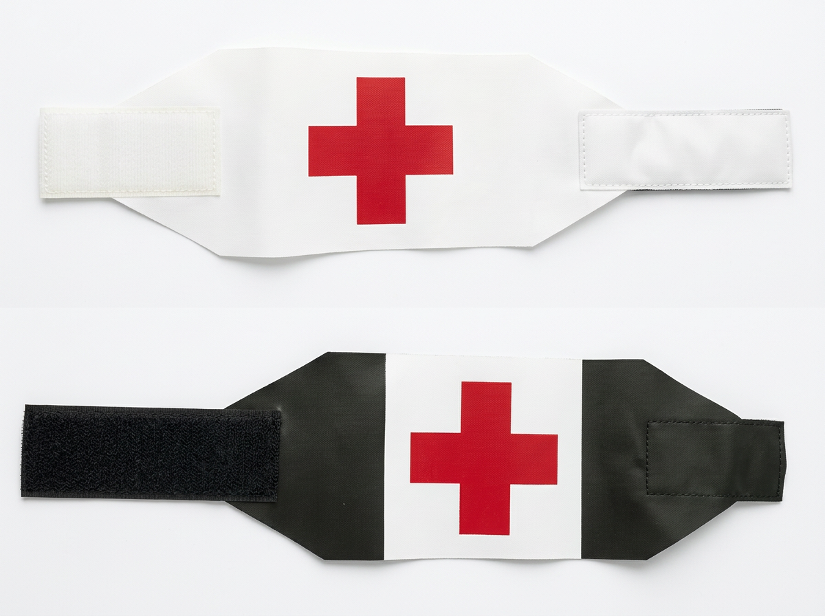 White and black velcro medic armbands with red cross insignias